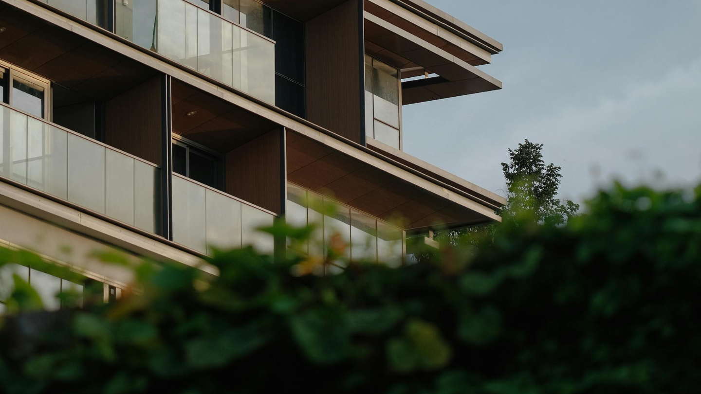 Modern multi-storey apartment building with cantilevered balconies and glass railings