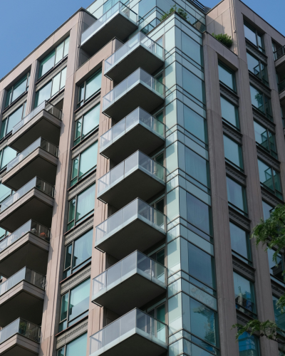 BC high-rise residential tower with stacked glass-railing balconies tracked under Sentinel oversight