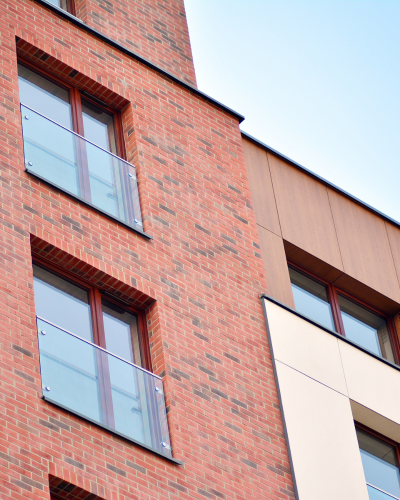 BC mid-rise brick and composite-panel building documented through Sentinel oversight