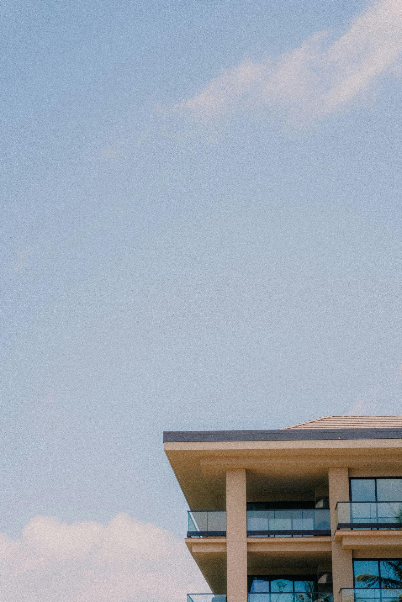 Upper roofline and parapet edge of a mid-rise residential building