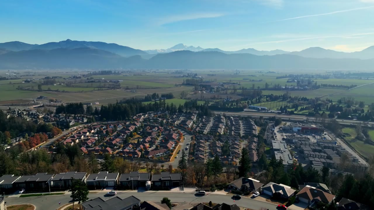 Aerial view of Fraser Valley residential communities with mountains in the background