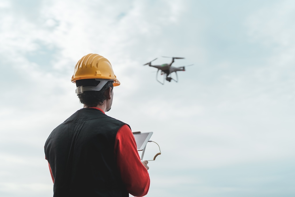 Drone inspecting building envelope from above